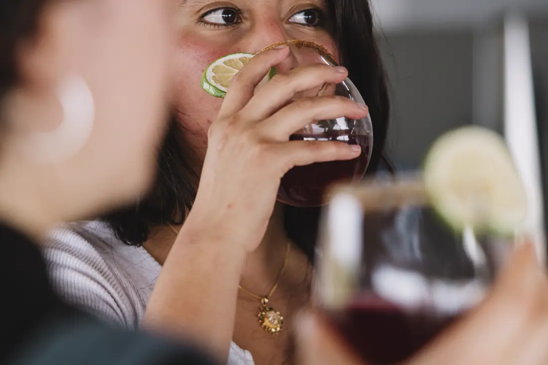 A guest raising a glass of Amazonian welcome drink at the lodge