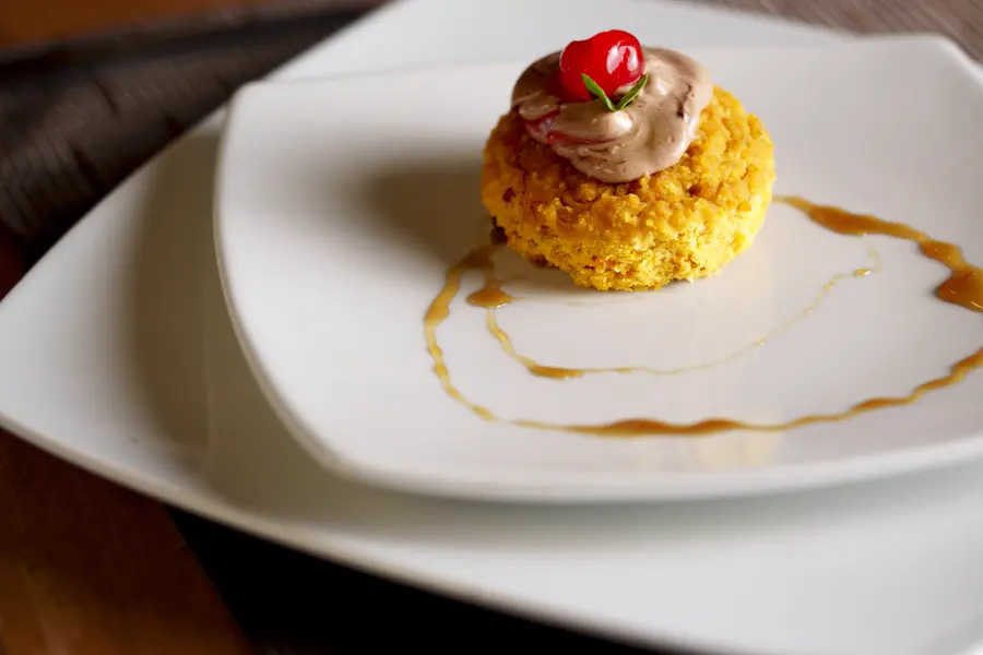 A plated dessert with a caramel line across the plate